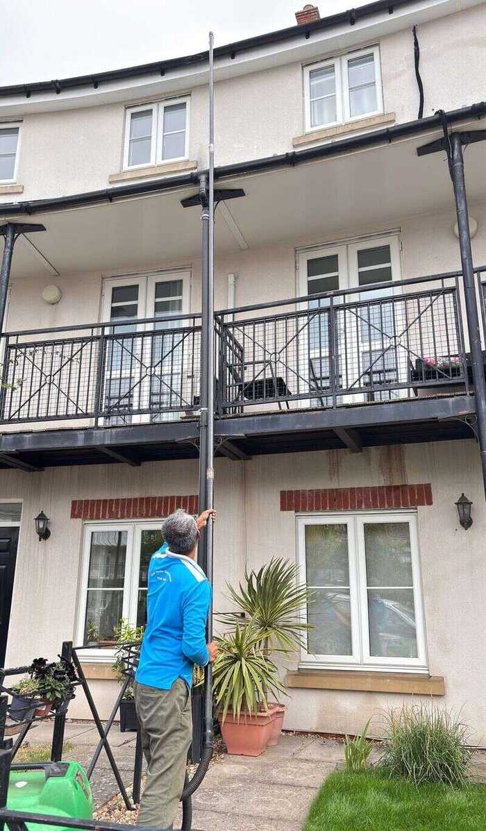 Gutter cleaning with a vacuum pole on a residential property