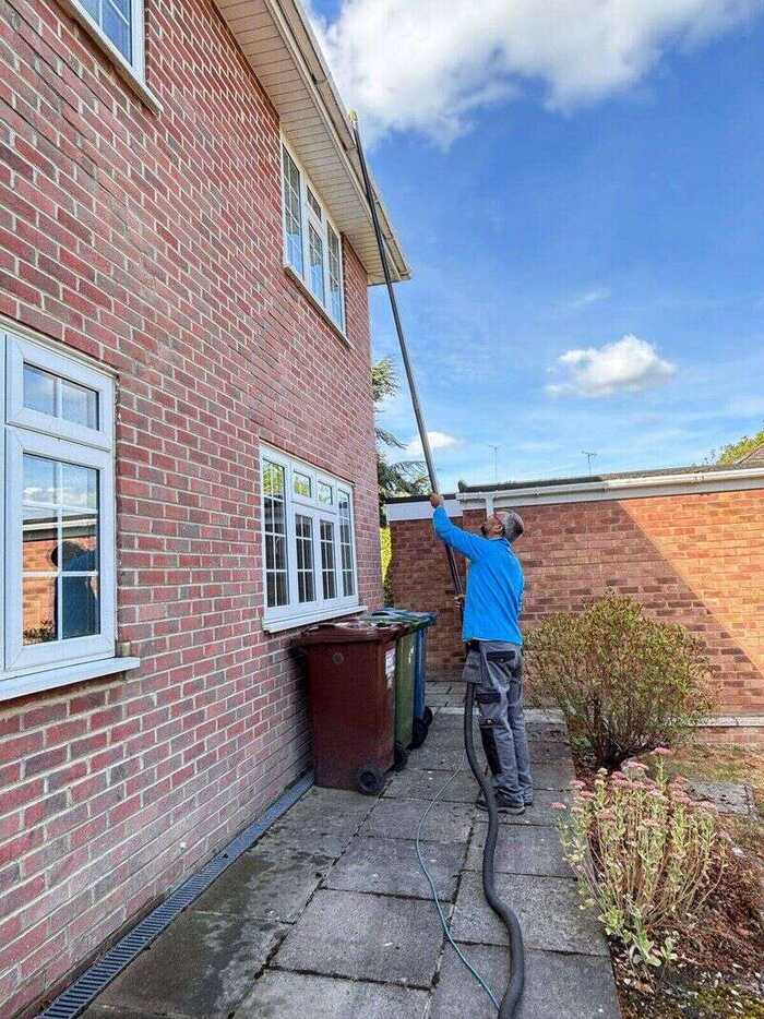 Gutter clearing from ground level using a pole-mounted vacuum